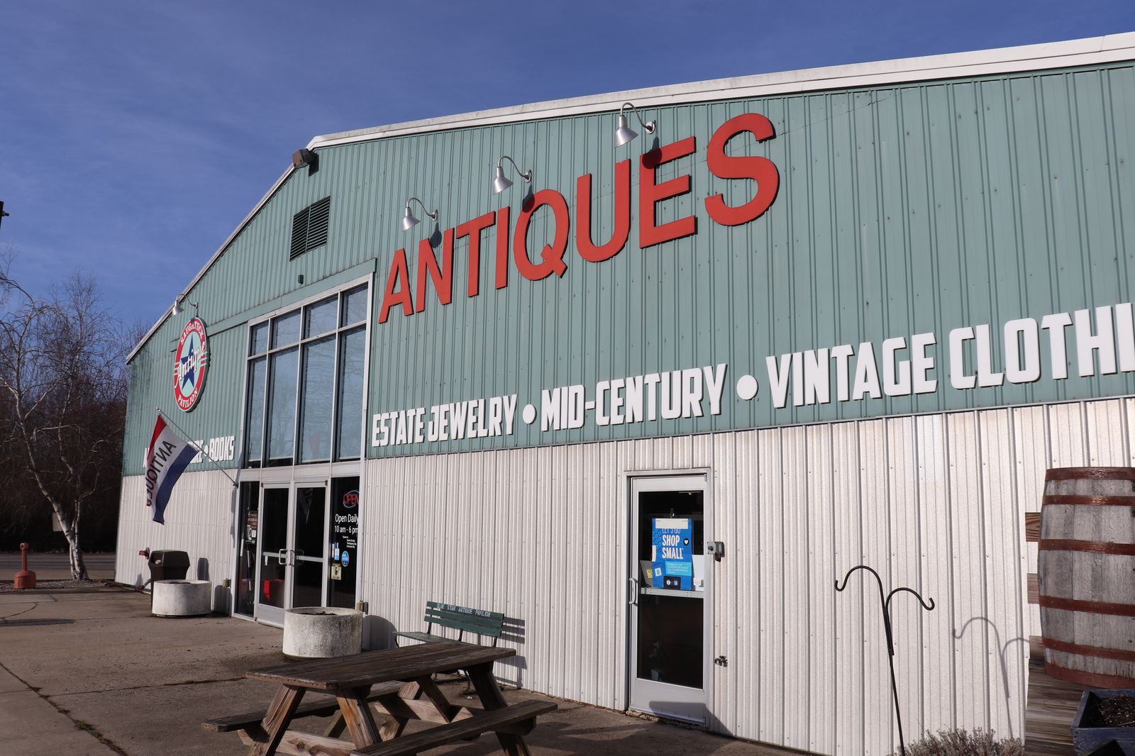 Exterior of Saugatuck Antique Pavilion in Douglas, Michigan, showing the Antiques sign and entrance, open daily 10am-6pm